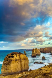 Travel to Australia. Pink dawn clouds over the rocks Twelve Apostles. Morning on the ocean shore.