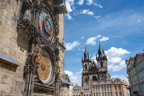 The famous astronomical clock and the Teyn Church in Prague on a sunny day