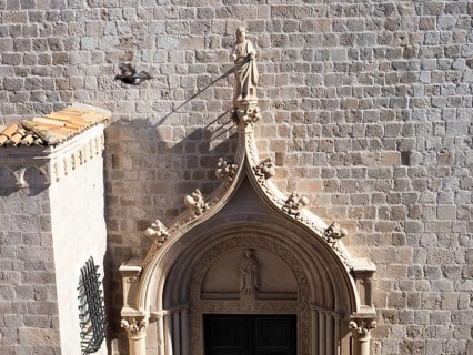 Sculpture, stone carving, figure of a saint above a church portal, Old Town of Dubrovnik, Dalmatia,
