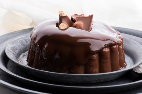 Chocolate pudding with chocolate dressing on a plate