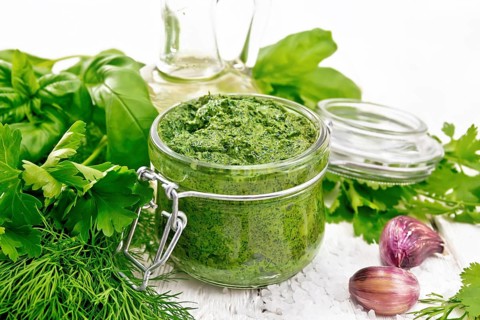 Sauce of dill, parsley, basil, cilantro, other spicy herbs, garlic and vegetable oil in a glass