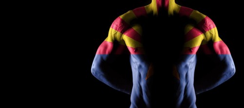 Arizona flag on muscled male torso with abs, Arizona bodybuilding concept, black background
