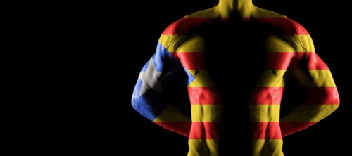 Catalonia flag on muscled male torso with abs, black background