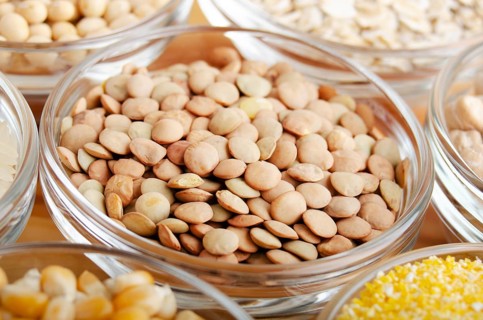 Lentils closeup in glass bowl on wooden kitchen table, non-perishable, long shelf life food concept