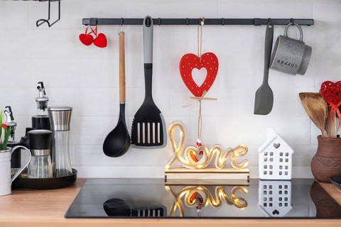 The interior of the kitchen in the house is decorated with red hearts for Valentine's Day. Decor on