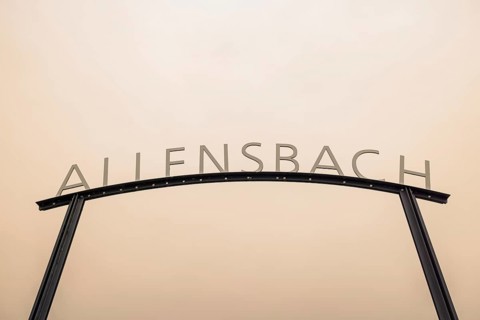 Metal sign with the lettering Allensbach in front of a beige sky with Sahara dust, harbour,