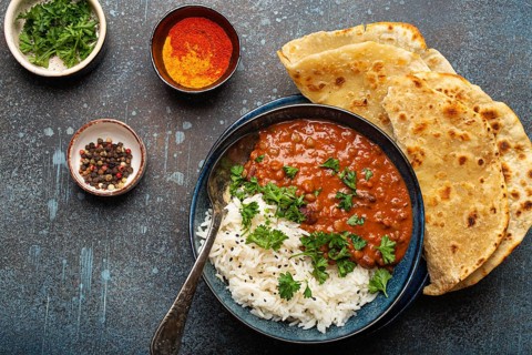 Traditional Indian Punjabi dish Dal makhani with lentils and beans in black bowl served with