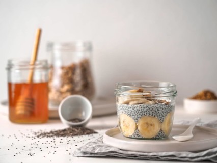 Healthy breakfast concept and idea - chia pudding with organic banana and bee pollen. Glass jar