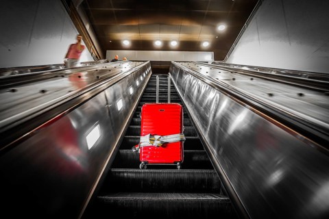 Escalator and suitcase. Shooting Location: New York, Manhattan