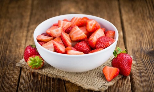 Fresh made Chopped Strawberries on a vintage background as detailed close-up shot