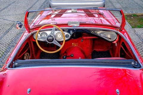 Lisbon, Portugal, Jan 20, 2024: Original red interior of red Austin-Healey 100 vintage convertible