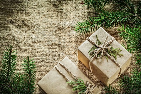 Present boxes thuya pine tree branch on sacking background
