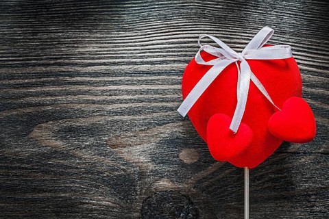 Red fabric hearts on wooden board celebrations concept