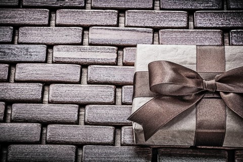 Present with ribbon on wooden mat horizontal view holidays concept