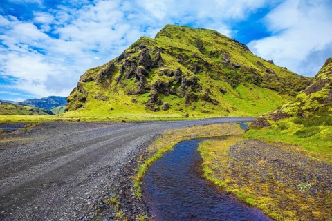 Picturesque basalt hills covered with green grass and moss-polar. At the bottom of the canyon