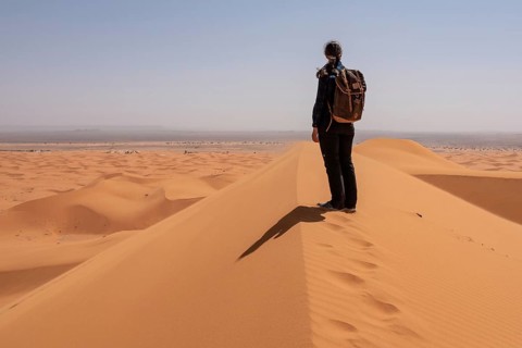 Hiking up the Great Dune of Merzouga in the Erg Chebbi desert, Moroccan Sahara desert