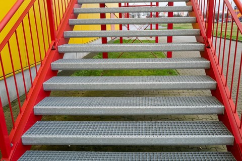 Red metal stairway at factory