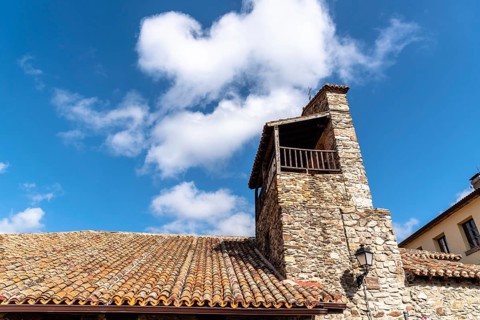 Old stone church in Puebla de la Sierra in the mountain range of Madrid