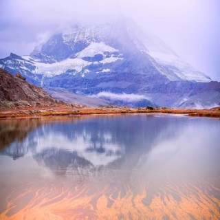 Colorful pink sunrise and reflection of Matterhorn mountain at Riffelsee lake, Zermatt Switzerland