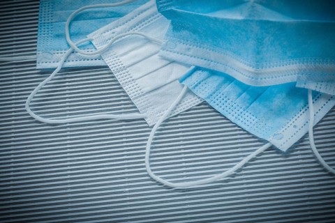 Composition of surgical sterile masks on striped background
