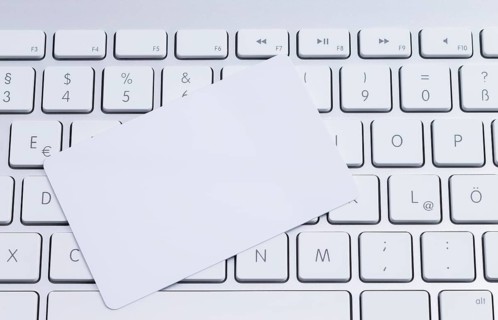 White keyboard with a blank white pastille card