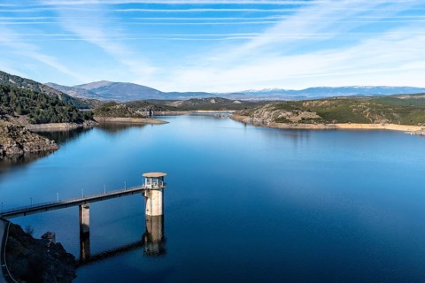 The Atazar reservoir and control tower of Dam in the mountain range of Madrid