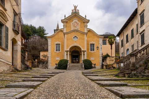 Orta San Giulio, Italy, 13 March, 2023: steep cobblestone street leading to the historic Penotti