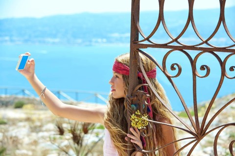 Blond girl selfie photo in mediterranean sea gate at Spain