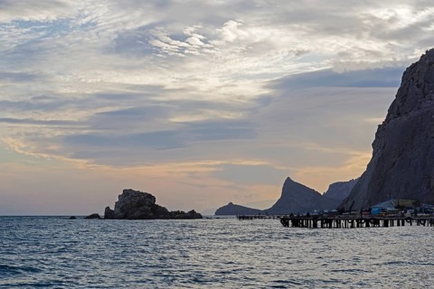Sunset in the bay of the resort town of Sudak. Crimea