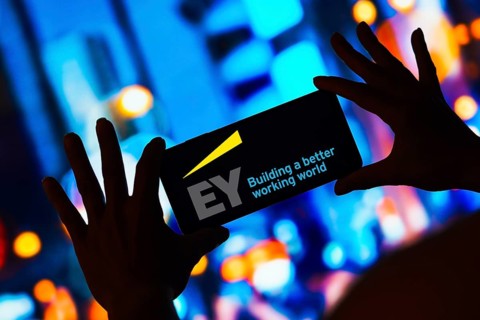 In this photo illustration, the Ernst and Young Global Limited (EY) logo is displayed on a