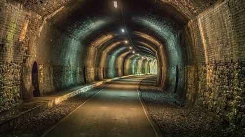 Walking through the Headstone Tunnel, near Monsal Head in the East Midlands, Derbyshire, Peak