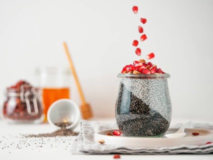 Healthy breakfast concept and idea - two colors chia pudding with organic raw pomegranate. Glass