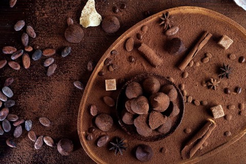 Healthy delicious chocolate truffles around ingridients with natural cocoa beans, powder, cacao