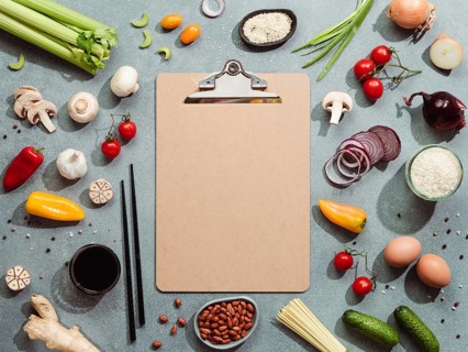 Asian ingredients and empty clipboard. Various of Chinese cooking ingredients and chopsticks on
