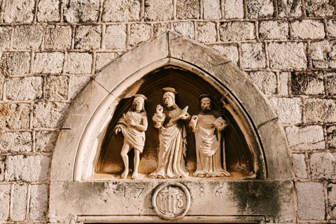 Dubrovnik, Croatia - 04 may 2016: Close-up stone statues, bas-reliefs and high reliefs on the walls