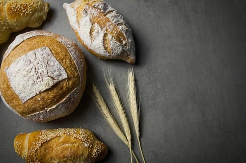 Beautiful Sourdough bread on gray background with dried wheat flower