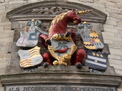 Stone relief with a red unicorn and several colourful coats of arms, hoorn, ijsselmeer, netherlands