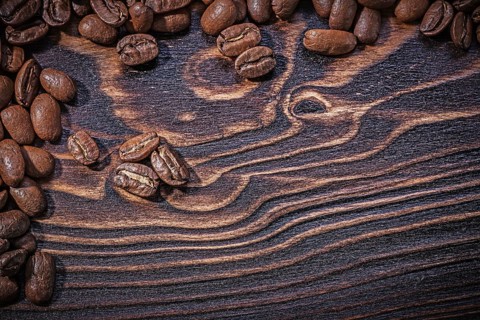 Roasted natural coffee beans on vintage wooden board