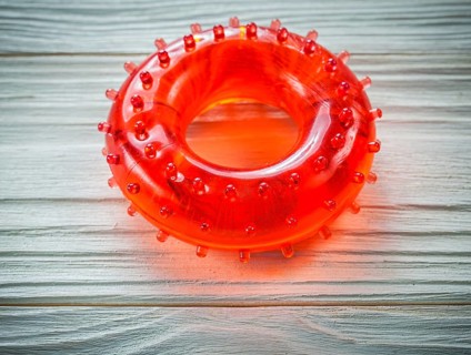 Rubber round hand grip strengthener on wooden board sports training concept