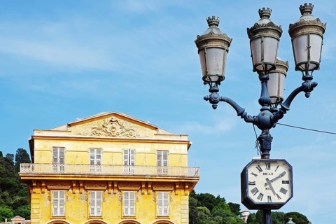 Street lamp with clock in front of the