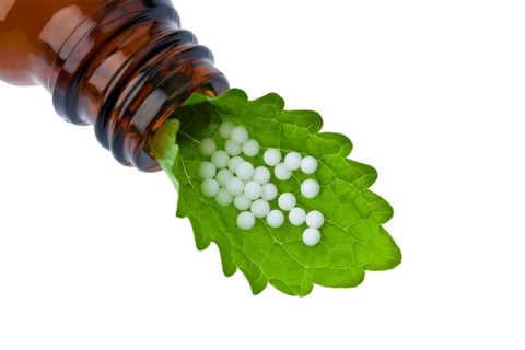 Homeopathy. Globules as an alternative medicine. Lying on a sheet, Homeopathy. Globules as