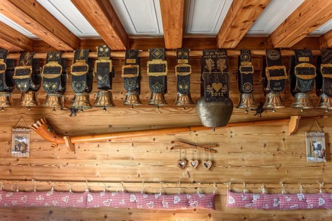 Cow bells displayed in restaurant of mountain farm. Vosges, Alsace, France, Europe