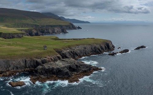 Aerial view of the rugged coastline of County Donegal at Malin Beg with the ruins of the Napoleonic
