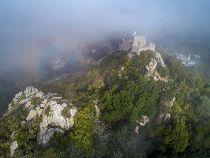 Aerial view of Castelo dos Mouros or Moorish Castle in fog, Sintra, Portugal, Europe