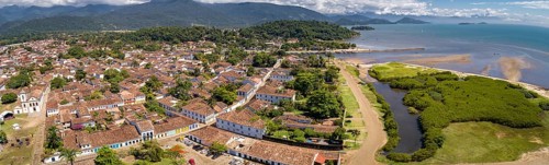 Panoramic aerial view to historic town Paraty with green mountains and sea in background on a sunny