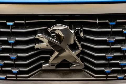 WETZLAR, Germany 2022-04-23: Peugeot logo closeup on a car grill. Peugeot as car manufacturer was