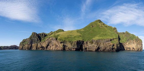 Steep cliffs in the blue sea, Westman Islands, Iceland, Europe
