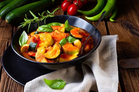 Vegetarian courgette ratatouille with tomato sauce and herbs