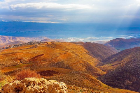 Legendary Dead Sea. Ancient terracotta-colored mountains surround the healing waters of the Dead