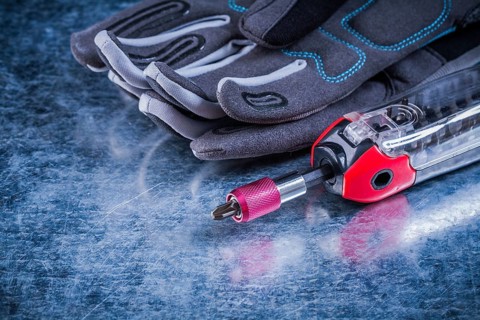Threaded muunction screwdriver fabric protective gloves on metallic background
